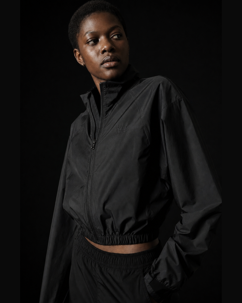 Model wearing Originals CA cropped black ultra jacket, studio portrait