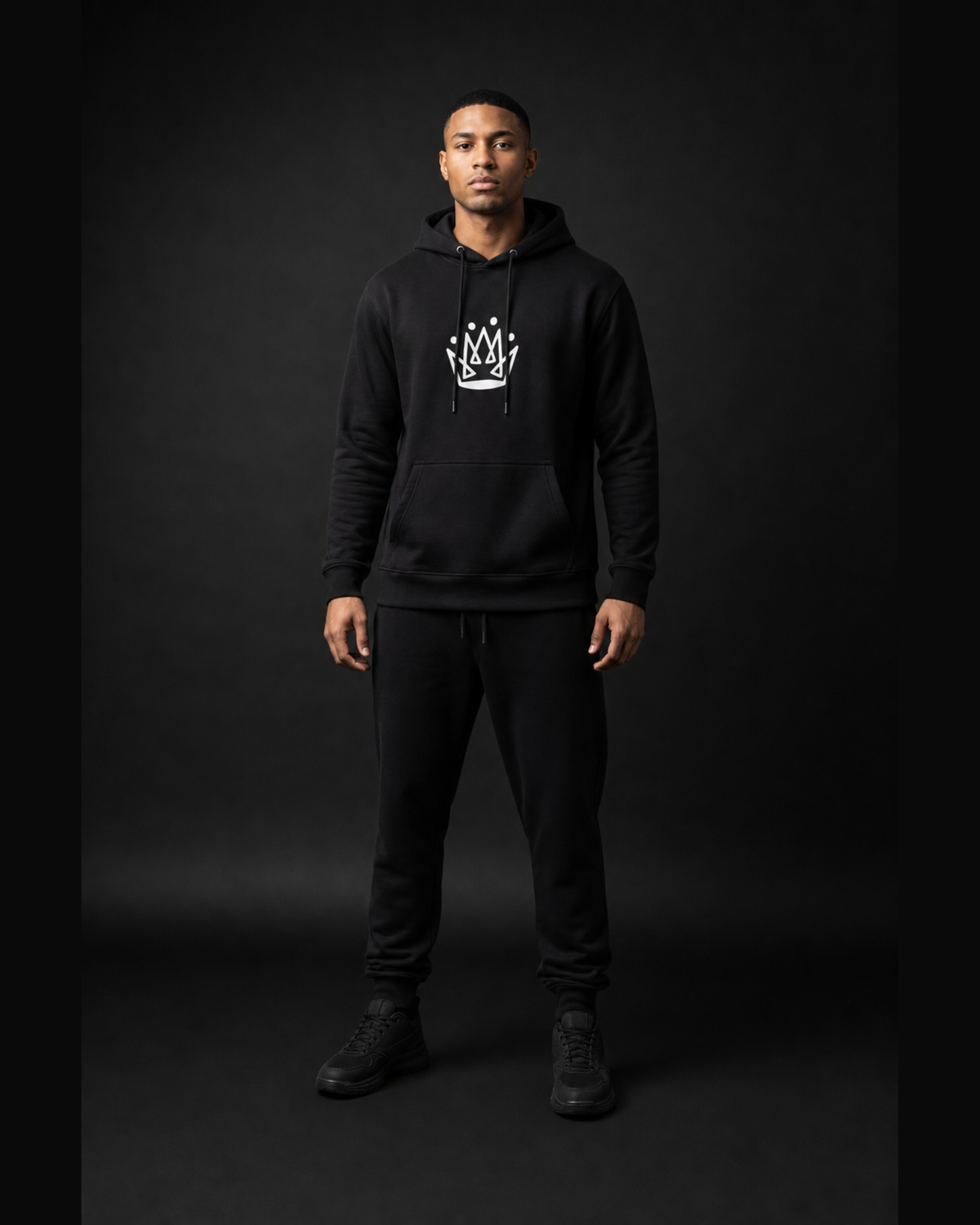 Model wearing Originals CA black pullover hoodie with crown emblem, studio portrait