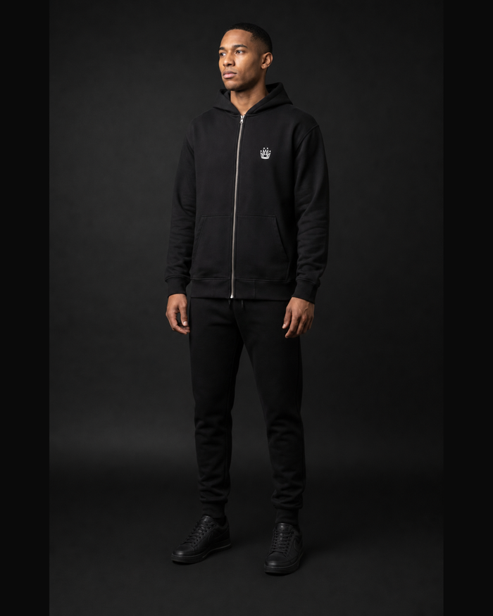 Model wearing Originals CA black zip hoodie with crown, studio portrait