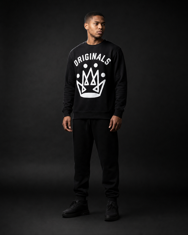 Model wearing Originals CA matte black crewneck sweatshirt with crown emblem, studio portrait