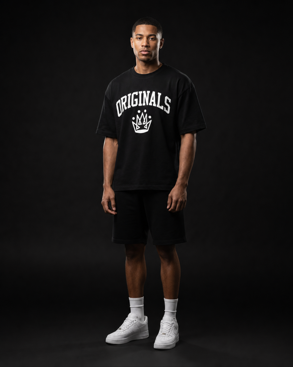 Model wearing Originals CA heavyweight black tee with crown emblem, studio portrait