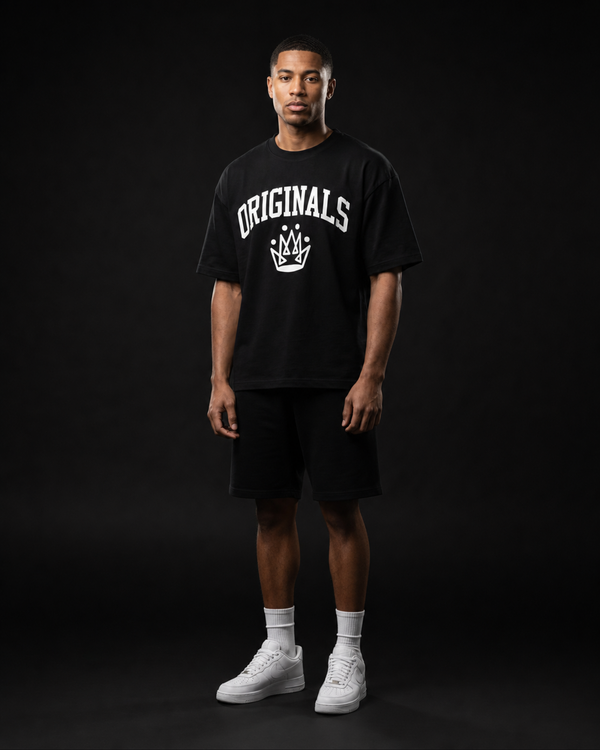 Model wearing Originals CA heavyweight black tee with crown emblem, studio portrait