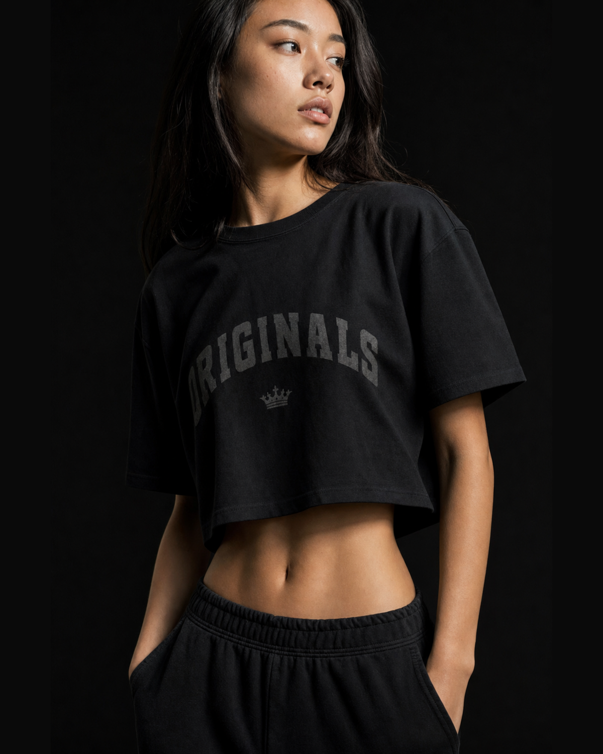Model wearing Originals CA cropped black tee with crown, studio portrait