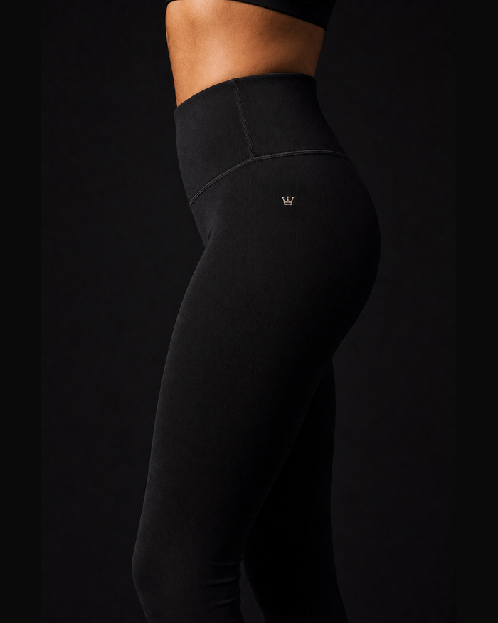 Model wearing Originals CA black high-rise compression leggings, studio portrait