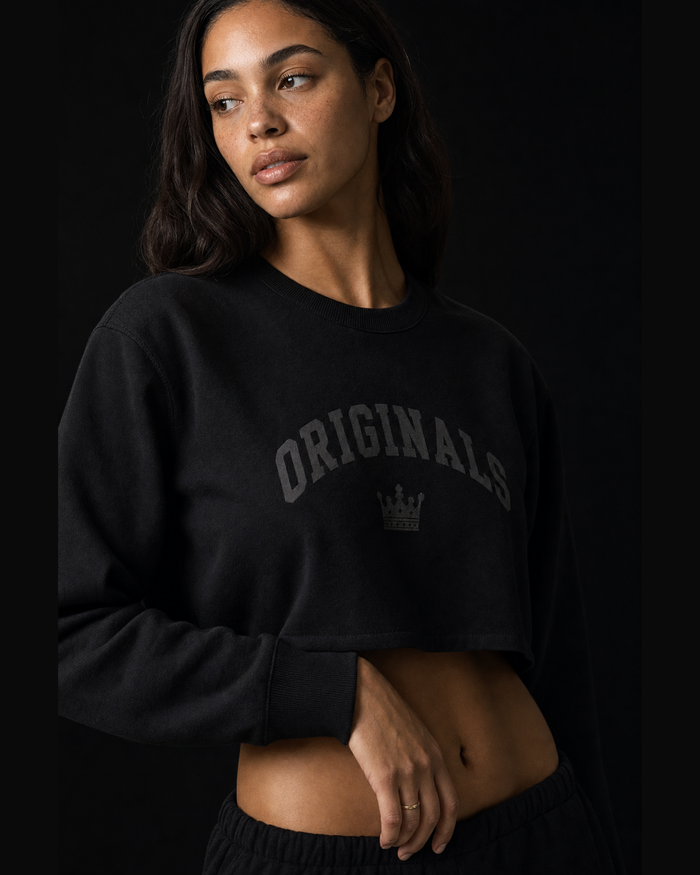 Model wearing Originals CA black long sleeve crop with crown, studio portrait