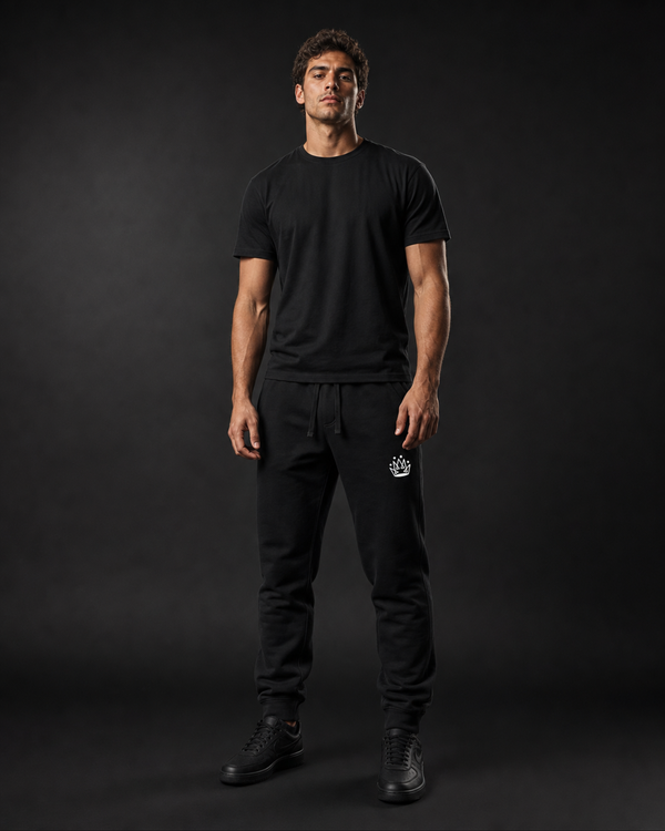 Model wearing Originals CA black sweatpants with crown embroidery, studio portrait