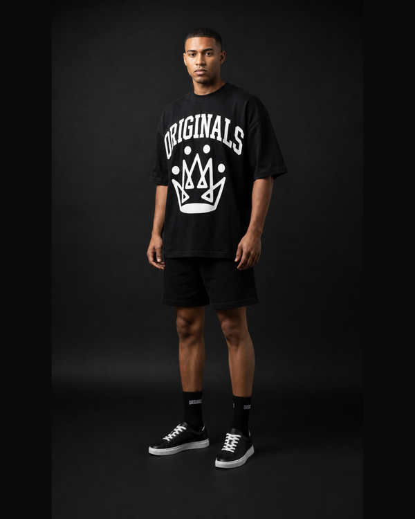 Model wearing Originals CA oversized black logo tee, studio portrait