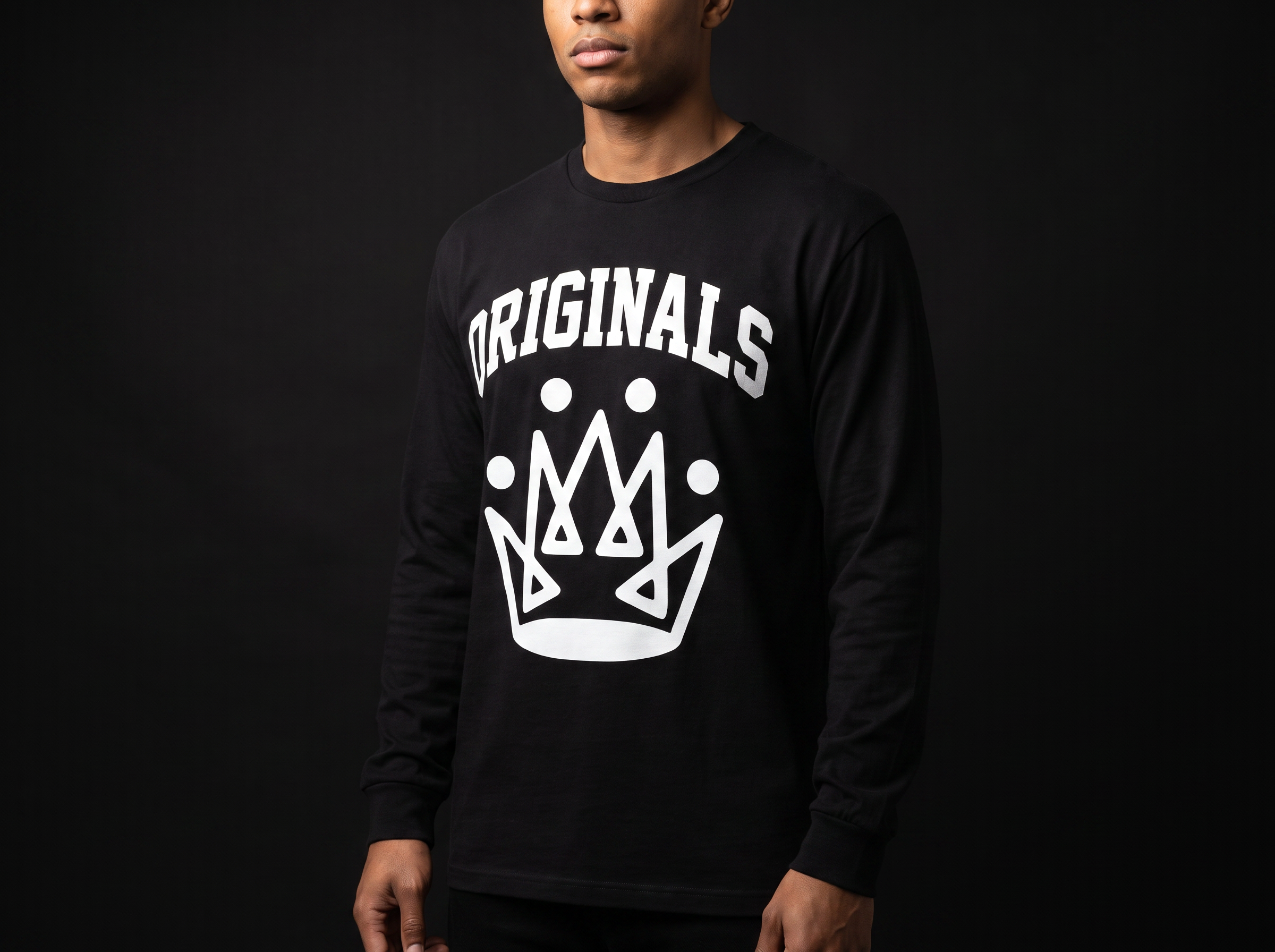Model wearing Originals matte-black long sleeve tee with white ORIGINALS crown across chest