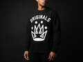Model wearing Originals matte-black crewneck sweatshirt with white ORIGINALS crown across chest