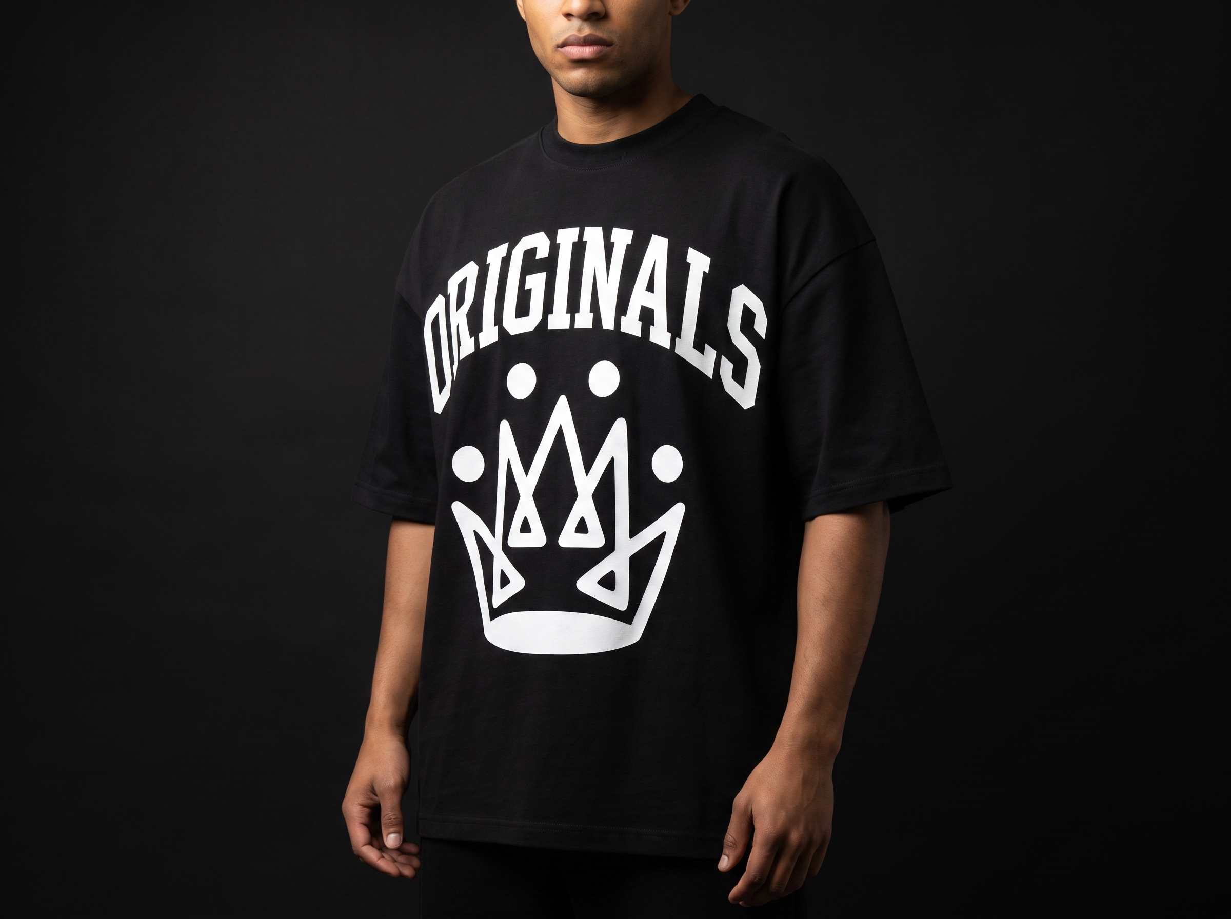 Model wearing Originals matte-black oversized logo tee with large white ORIGINALS crown across chest