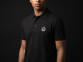 Model wearing Originals matte-black polo with embroidered white crown
