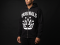 Model wearing Originals matte-black full-zip hoodie with white ORIGINALS crown across chest