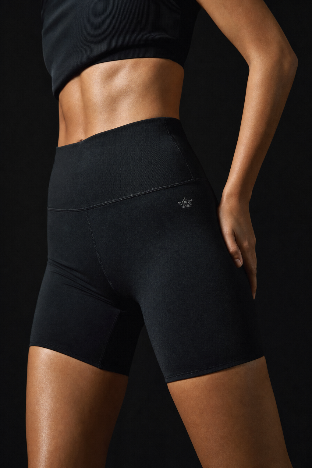 Model wearing Originals black high-waisted bike shorts with crown embroidery