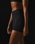Model wearing Originals high-waisted training shorts with crown